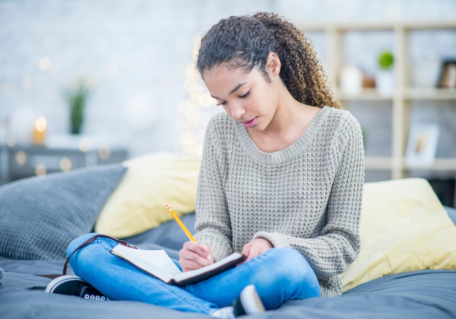 Young woman writing in notebook