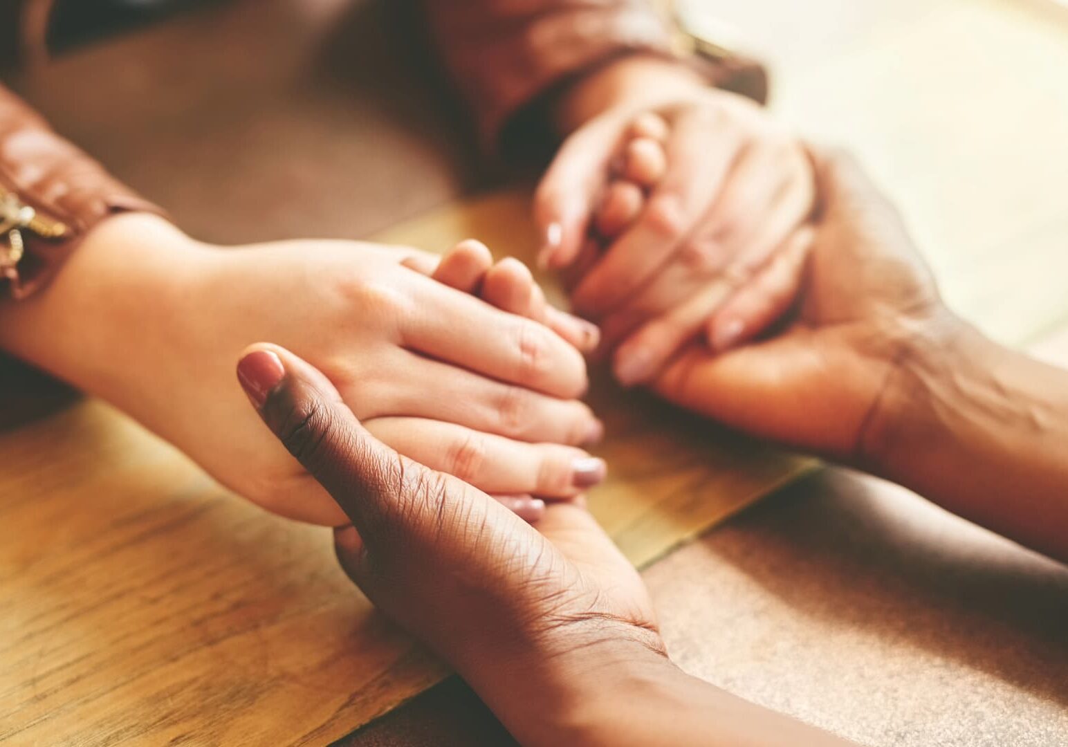 Woman holding another woman's hands-comforting